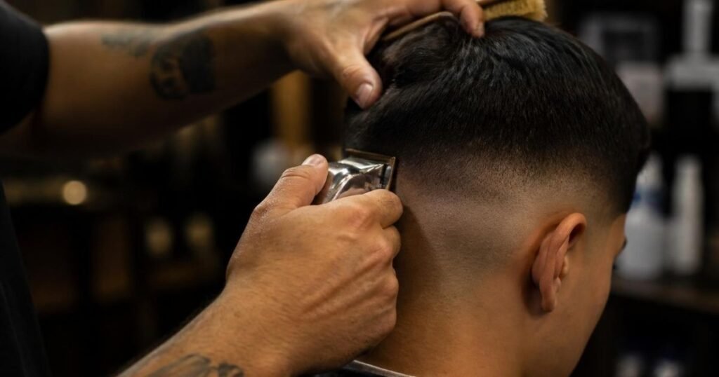 A skilled barber carefully cutting a precise, clean fade haircut